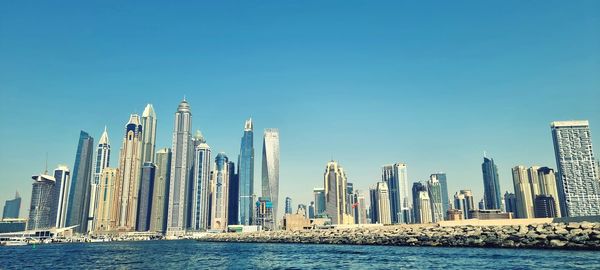 Panoramic view of modern buildings against clear sky