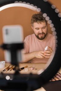 Portrait of young man using mobile phone