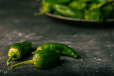 Close-up of green chili pepper on table