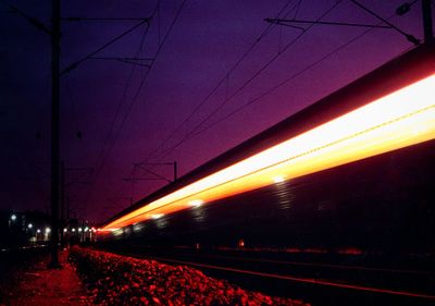 Blurred motion of train on road at night