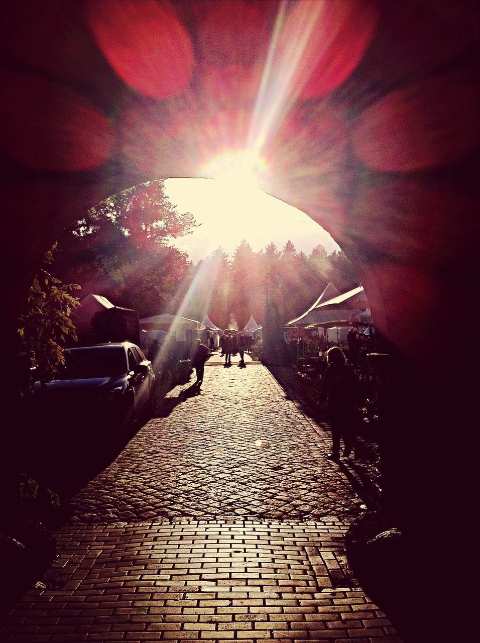 sun, sunbeam, sunlight, lens flare, lifestyles, the way forward, person, leisure activity, men, shadow, sunny, large group of people, bright, street, walking, medium group of people, cobblestone, transportation, architecture