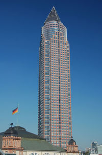 Low angle view of modern building against clear blue sky