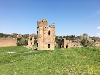 Old ruin building on field against clear sky