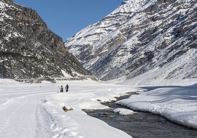 Scenic view of snow covered mountains against sky