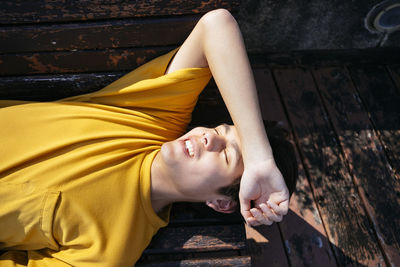 High angle view of woman lying on sofa