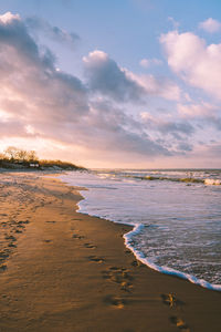 Scenic view of beach against sky during sunset