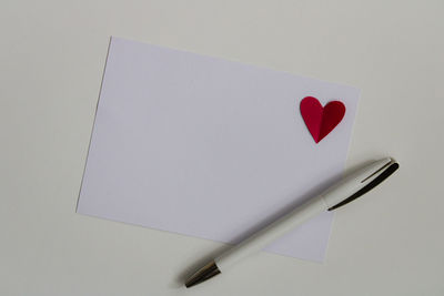 High angle view of pen and book on white background