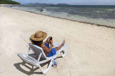 People sitting on chair at beach