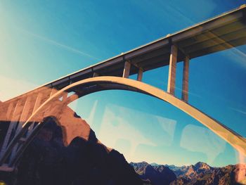 Low angle view of arch bridge against sky