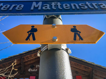 Low angle view of road sign against sky
