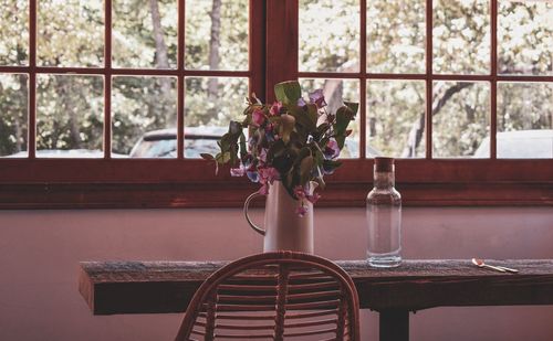 Close-up of potted plant on table by window