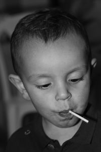 Close-up of boy eating lollipop