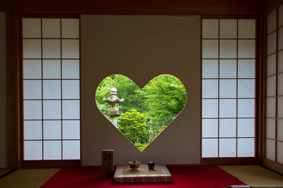 Close-up of heart shape on table against wall