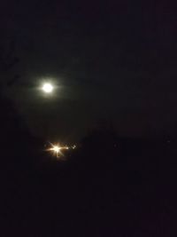 Low angle view of illuminated moon at night