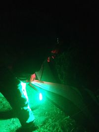Man in illuminated traditional clothing at night