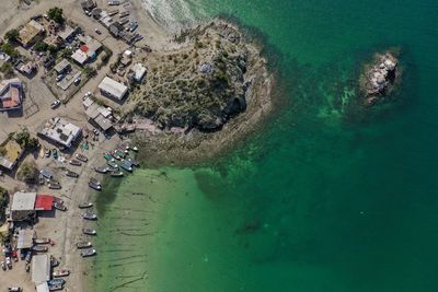 High angle view of sea and buildings in city