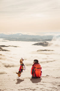 Girl with a dog playing in snow