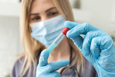 Young woman holding dentures