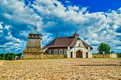 Temple by building against sky during autumn