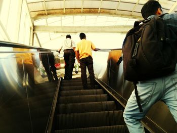 Man standing on escalator