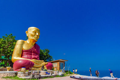Low angle view of statue against blue sky