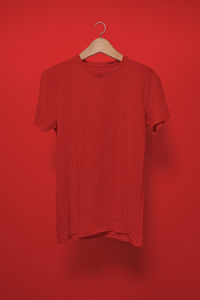 Red bell hanging against orange background