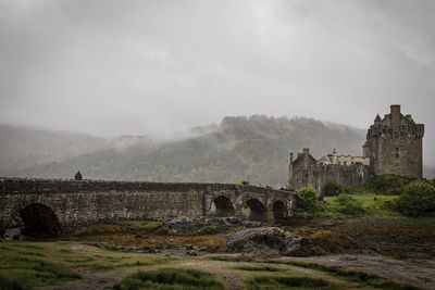 Old ruins of building against cloudy sky