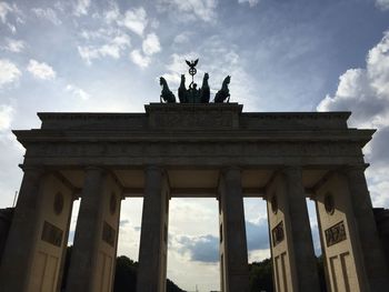 Low angle view of historical building against cloudy sky