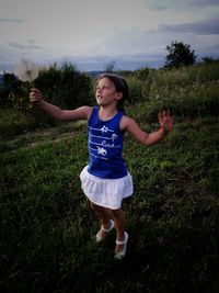 Full length of happy girl on field