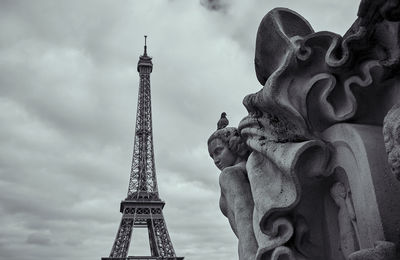 Statue of tower against cloudy sky