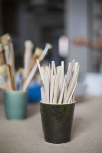 Wooden tools in container on table at workshop