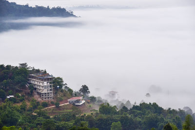 High angle view of buildings and trees against sky