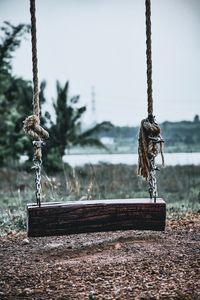 Close-up of swing against sky