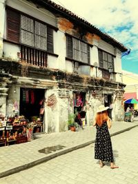 People at street market against buildings in city