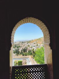 Buildings against clear sky seen through window