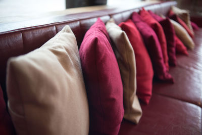 Colorful cushions arranged on sofa at home
