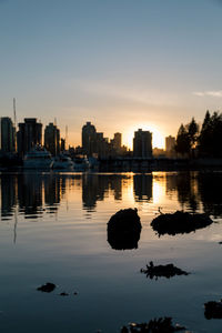 View of city at waterfront during sunset