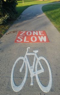 Close-up of bicycle sign on road
