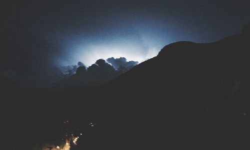 Scenic view of mountains against sky at night