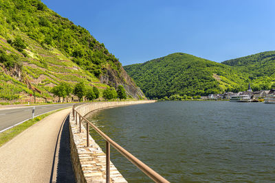 Beautiful view of the river flowing between the grape hills along the road in western germany.