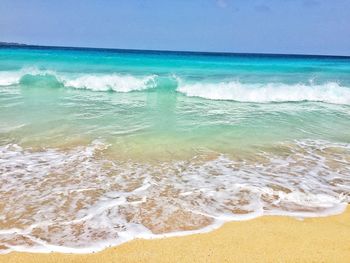 Scenic view of beach against blue sky