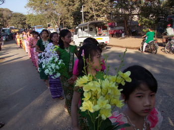 Children playing with flowers in background