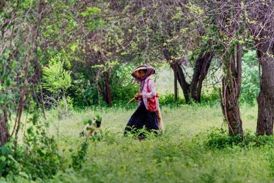 Woman walking on grassland