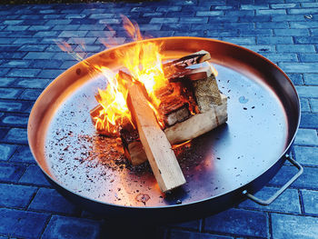 High angle view of burning candles on wooden table