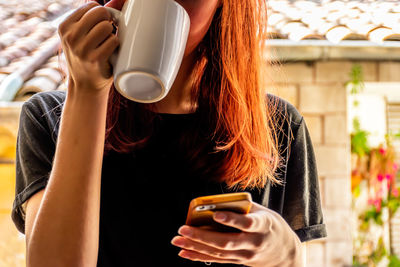 Midsection of woman using mobile phone