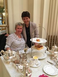 Happy friends sitting on table