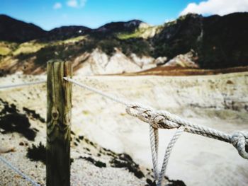 Close-up of water on mountain against sky