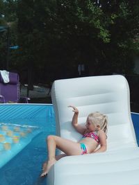 Girl sitting on inflatable raft
