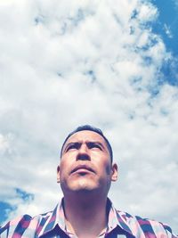 Low angle view of man against cloudy sky