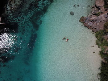 High angle view of people swimming in sea